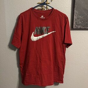 Nike red tee. “Nike” in black with white check.